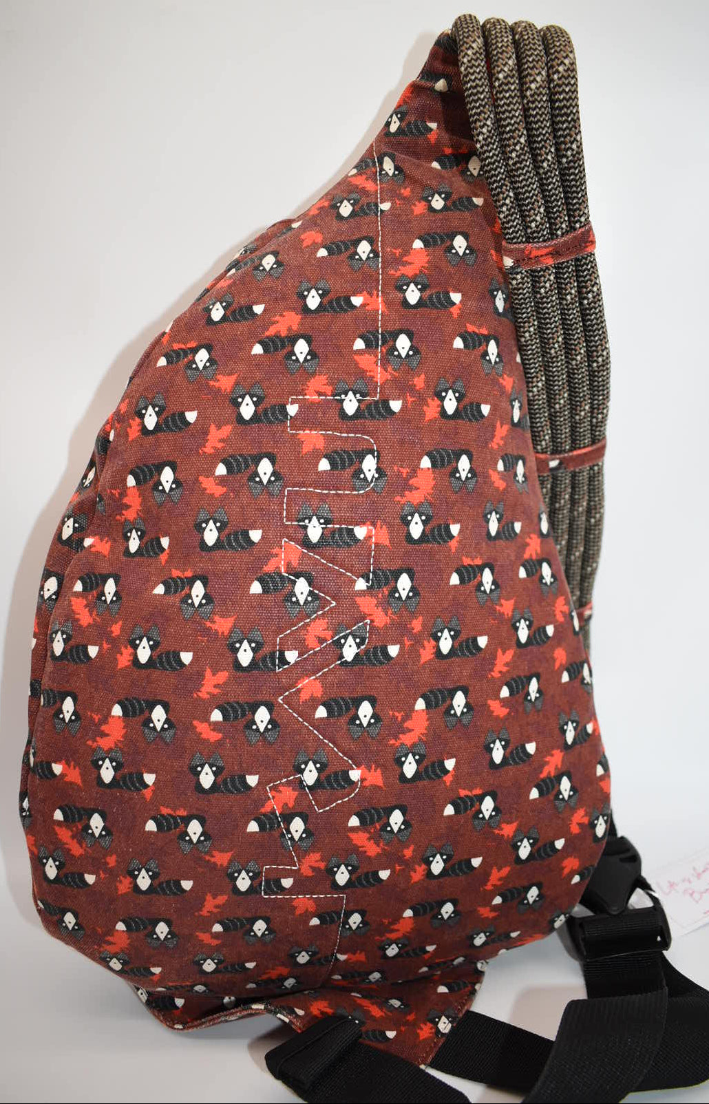 Kavu Rope Sling Bag in Red Critters Racoon
